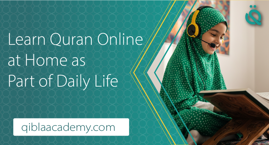 A young girl in a green polka-dot hijab and headphones smiling while reciting Quran from a wooden stand at home.