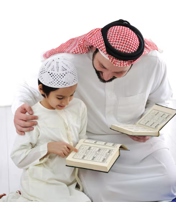Father and son sitting together reading and reviewing the Quran from open Mushafs.